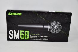 An as new Shure SM58 legendary vocal microphone.