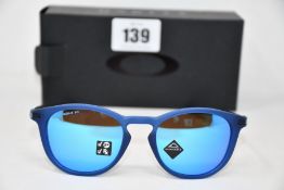 A pair of as new Oakley Pitchman R glasses matte translucent blue frame with Prizm Sapphire