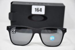 A pair of as new Oakley Apparition sunglasses Satin Black frame with Black iridium Polarized