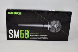 An as new Shure SM58 legendary vocal microphone.