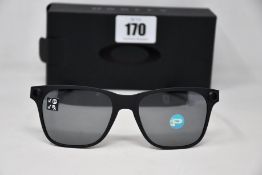 A pair of as new Oakley Apparition sunglasses Satin Black frame with Black iridium Polarized
