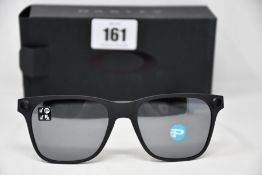 A pair of as new Oakley Apparition sunglasses Satin Black frame with Black iridium Polarized
