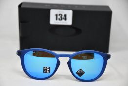 A pair of as new Oakley Pitchman R glasses matte translucent blue frame with Prizm Sapphire