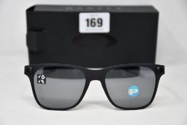 A pair of as new Oakley Apparition sunglasses Satin Black frame with Black iridium Polarized