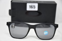 A pair of as new Oakley Apparition sunglasses Satin Black frame with Black iridium Polarized