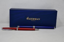 Two Waterman Hemisphere Rollerball Pens (One red, one light blue), a Parker 51 Ballpoint Pen in