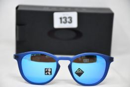 A pair of as new Oakley Pitchman R glasses matte translucent blue frame with Prizm Sapphire