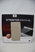 A boxed as new Native Instruments Traktor Scratch A6 digital vinyl system (Some damage to box).