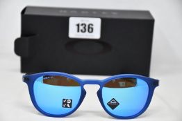 A pair of as new Oakley Pitchman R glasses matte translucent blue frame with Prizm Sapphire