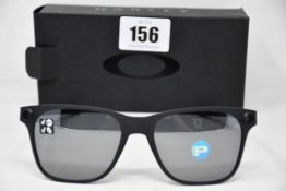 A pair of as new Oakley Apparition sunglasses Satin Black frame with Black iridium Polarized
