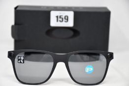A pair of as new Oakley Apparition sunglasses Satin Black frame with Black iridium Polarized