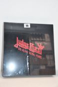 An as new Judas Priest 50 Heavy Metal Years collectors book.