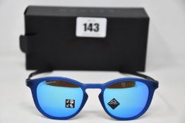 A pair of as new Oakley Pitchman R glasses matte translucent blue frame with Prizm Sapphire