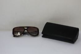 A pair of as new Chanel sunglasses.