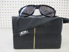 Two boxed of as new Oakley Anorak sunglasses polished black frame with prizm grey lenses (