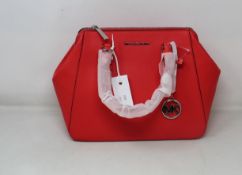 An as new Michael Kors Charlotte bag in coral reef.