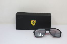 A pair of as new Ray Ban Ferrari sunglasses.