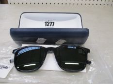 A pair of as new Lacoste sunglasses.