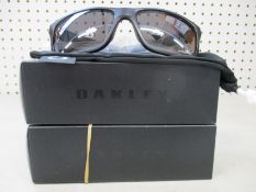 Two boxed as new Oakley Mainlink XL sunglasses matte black frame with prizm black polarized