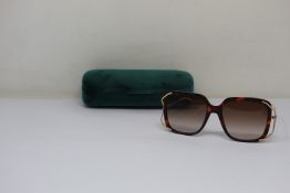 A pair of as new Gucci sunglasses.