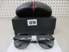 A pair of as new Prada sunglasses.