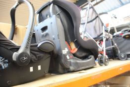 Three pushchairs/buggies and two car seats/booster seats.