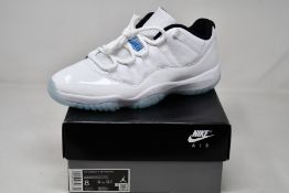A pair of as new Nike Air Jordan 11 Retro Low (UK 7).