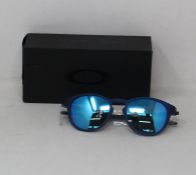 A boxed as new pair of Oakley Pitchman R glasses matte translucent blue frame with Prizm Sapphire