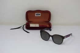 A pair of as new Gucci sunglasses.