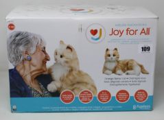 A Joy For All Companion orange tabby cat.