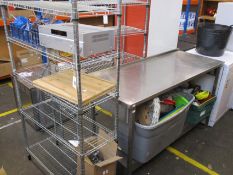 A stainless steel preparation table, two sets of wire shelving, Sony multi channel AV receiver and