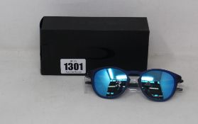 A boxed as new pair of Oakley Pitchman R glasses matte translucent blue frame with Prizm Sapphire