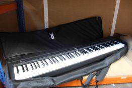 A pre-owned Yamaha P-45 digital piano with a travel case.