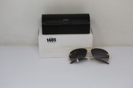 A pair of as new Cartier sunglasses.