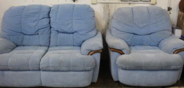 A blue two seater sofa together with an armchair.