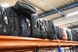 A quantity of empty suitcases/holdalls (Approximately 30 items).