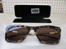 A pair of as new Calvin Klein sunglasses.