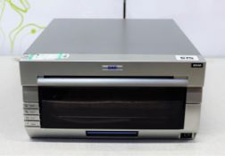 COLLECTION ONLY: A pre-owned DNP DS40 photo printer (Some cosmetic damage).