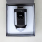 A Ring Spotlight Wired Surveillance Camera in Black (Possibly pre-owned, slight damage to casing.