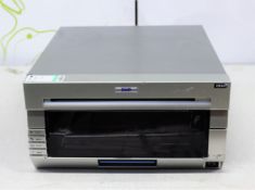 COLLECTION ONLY: A pre-owned DNP DS40 photo printer (Damage to front panel).