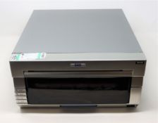 COLLECTION ONLY: A pre-owned DNP DS40 photo printer (Some cosmetic damage).