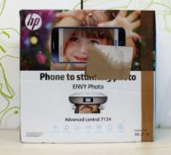 A boxed HP Envy Photo 7134 All-In-One printer in white (possibly pre-owned) (box opened) (sold as