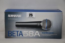 A boxed as new Shure Beta 58A vocal microphone.