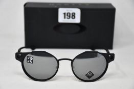 A boxed as new pair of Oakley Deadbolt sunglasses Satin Black frame with Prizm Black Polarized