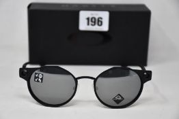 A boxed as new pair of Oakley Deadbolt sunglasses Satin Black frame with Prizm Black Polarized