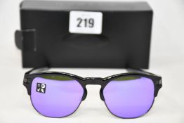 Two boxed as new Oakley Latch Key sunglasses polished black frames with violet iridium lenses (