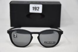 A boxed as new pair of Oakley Pitchman R glasses Satin Black frame with Prizm Black Polarized lenses
