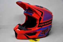 A boxed as new Fox Racing V1 Oktiv helmet in red (Small).