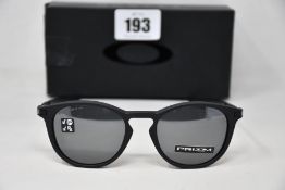 A boxed as new pair of Oakley Pitchman R glasses Satin Black frame with Prizm Black Polarized lenses