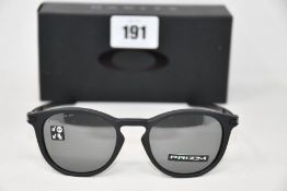A boxed as new pair of Oakley Pitchman R glasses Satin Black frame with Prizm Black Polarized lenses